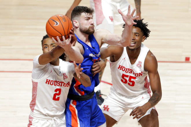 Houston guard Caleb Mills (2) strips a pass away from Boise State forward Mladen Armus, center, as forward Brison Gresham (55) looks on during the first half of an NCAA college basketball game Friday, Nov. 27, 2020, in Houston. (AP Photo/Michael Wyke)