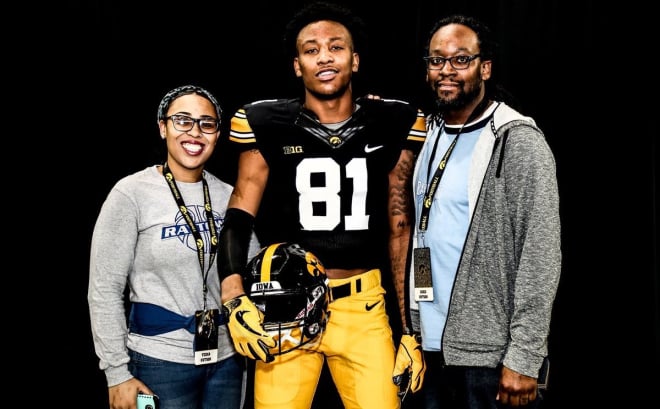 Desmond Hutson with his mother and father on their visit to Iowa this spring.