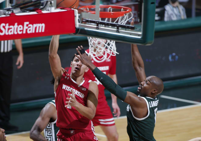 Wisconsin's Jonathan Davis, left, shoots against Michigan State's Joshua Langford during the first half. Wisconsin won 85-76.