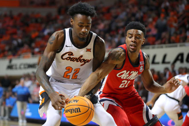 Oklahoma State Cowboys forward Kalib Boone (22) reaches for the ball beside Ole Miss forward Robert Allen (21) during a men's college basketball game between the Oklahoma State Cowboys (OSU) and the Ole Miss Rebels at Gallagher-Iba Arena in Stillwater, Okla., Saturday, Jan. 28, 2023. Oklahoma State won 82-60.