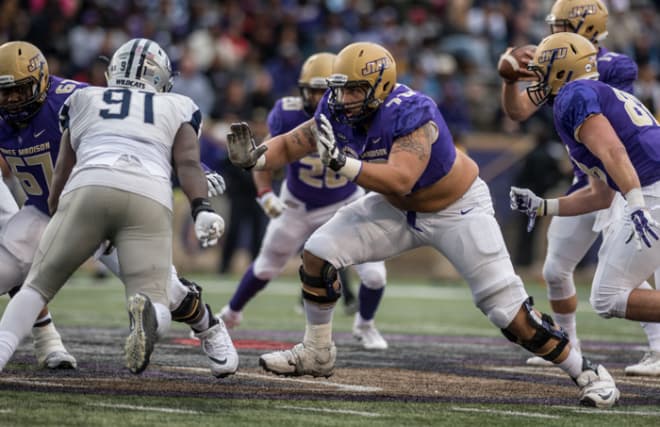 Former James Madison offensive tackle Aaron Stinnie blocks during the Dukes' win over New Hampshire this past October.