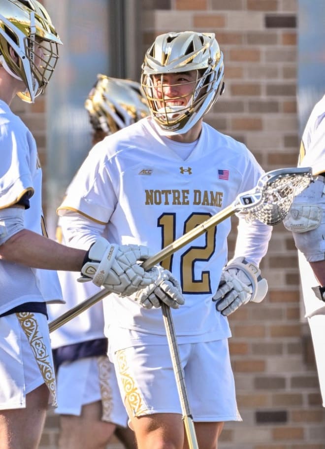 Former Notre Dame and Alabama quarterback Tyler Buchner (12) has been an asset this spring for the Irish men's lacrosse team.