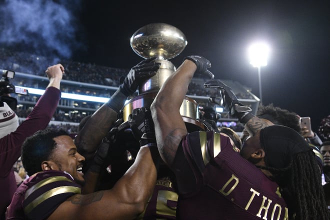 Mississippi State Bulldogs players react with the Egg Bowl Trophy after defeating the Ole Miss Rebels at Davis Wade Stadium. Mandatory Credit: Matt Bush-USA TODAY Sports