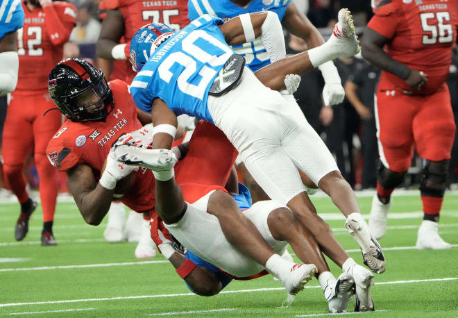 Texas Tech Red Raiders wide receiver Jerand Bradley (9) is tackled by Mississippi Rebels cornerback Davison Igbinosun (20) in the first half in the 2022 Texas Bowl at NRG Stadium. Mandatory Credit: Thomas Shea-USA TODAY Sports