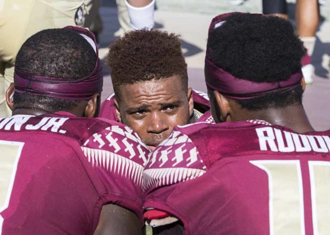 Francois huddles up with his receivers on the FSU bench.