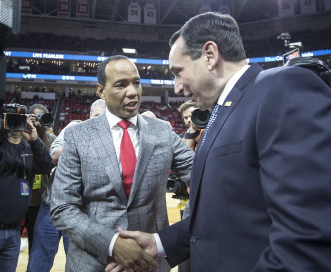 Head coaches Kevin Keatts (left) and Mike Krzyzewski shake hands before the game.