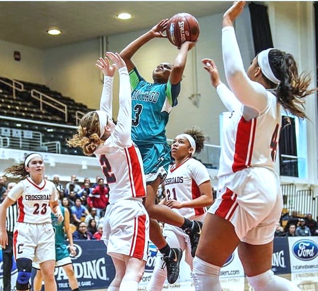 Londynn Jones (Santiago) draws a crowd as she rises for a floater in the lane.