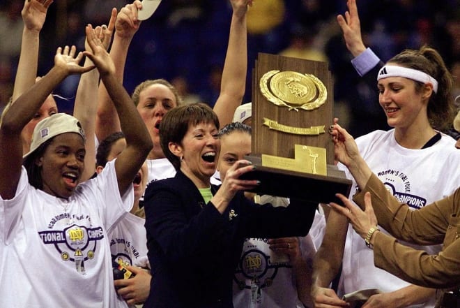 Former Notre Dame women's basketball coach Muffet McGraw celebrates the 2001 national title with her team.