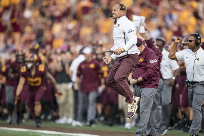 P.J. Fleck, pictured here jumping on the sidelines, has brought his energetic style to Minnesota.