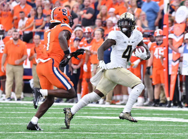 Sep 17, 2022; Syracuse, New York, USA; Purdue Boilermakers wide receiver Deion Burks (4) runs past Syracuse Orange defensive back Ja'Had Carter (1) after a catch in the fourth quarter at JMA Wireless Dome. Mandatory Credit: Mark Konezny-USA TODAY Sports