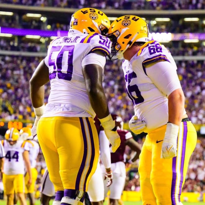 LSU true freshmen starting offensive tackles Emery Jones (50) and Will Campbell (66) "have that dog in them" according to Tigers' running back Josh Williams.
