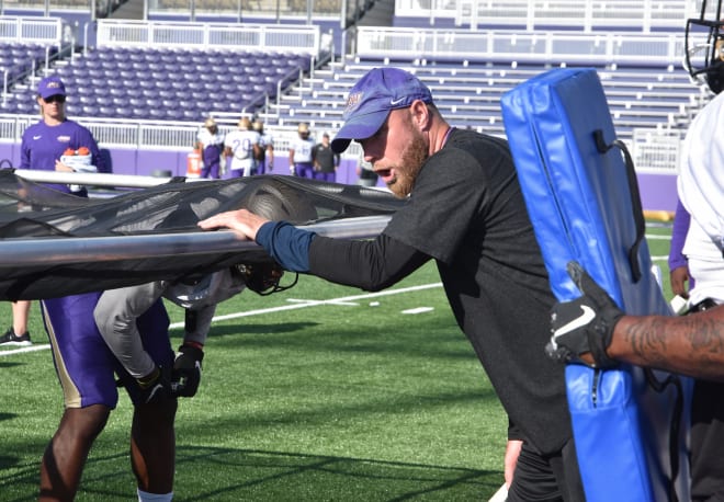 James Madison defensive coordinator and ends coach Corey Hetherman instructs a drill during Thursday's practice at Bridgeforth Stadium.