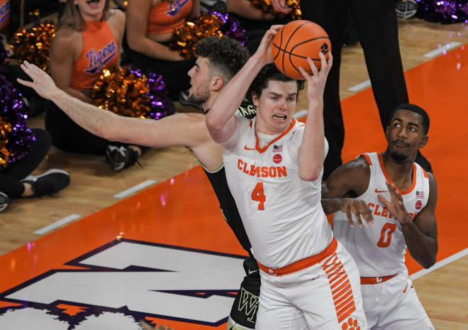 Clemson's Ian Schieffelin grabs a rebound in front of teammate Josh Beadle, right, and Wake Forest's Matthew Marsh during Friday night's game. 