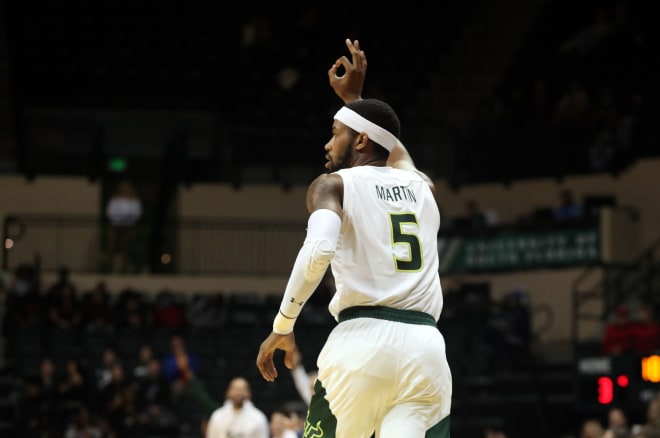 Malik Martin reacts after making a three pointer against Cincinnati during the first half at USF Sun Dome.