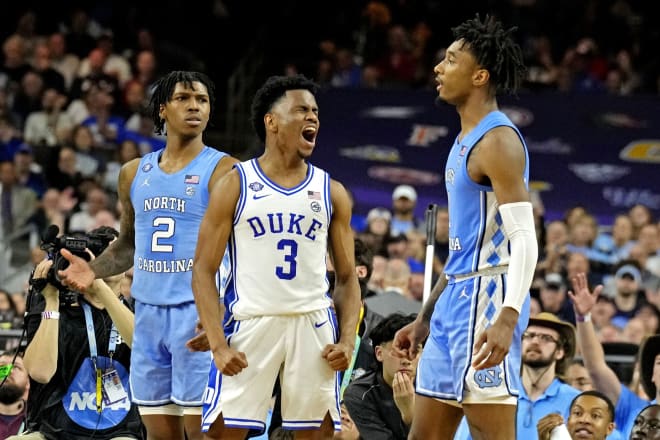 Duke's Jeremy Roach celebrates in between UNC's Caleb Love, left, and Leaky Black during last season's Final Four matchup. 