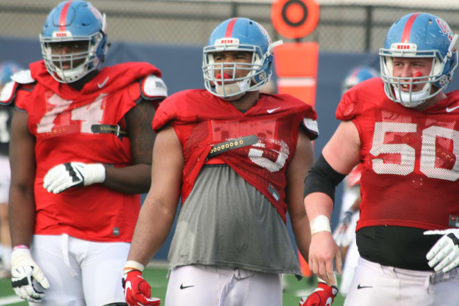 Ole Miss offensive linemen Greg Little (left), Javon Patterson and Sean Rawlings (50) look to the sideline for signals during team work Tuesday.