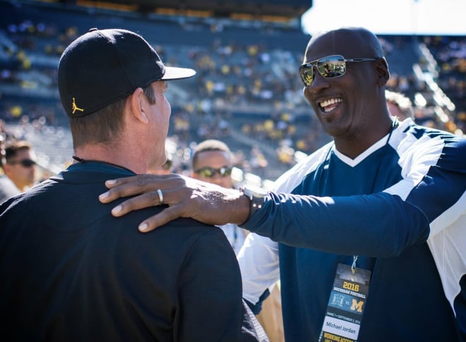 Michigan Wolverines football head coach Jim Harbaugh (left) and former NBA star Michael Jordan (right) before Michigan's game vs. Hawai'i in 2016.