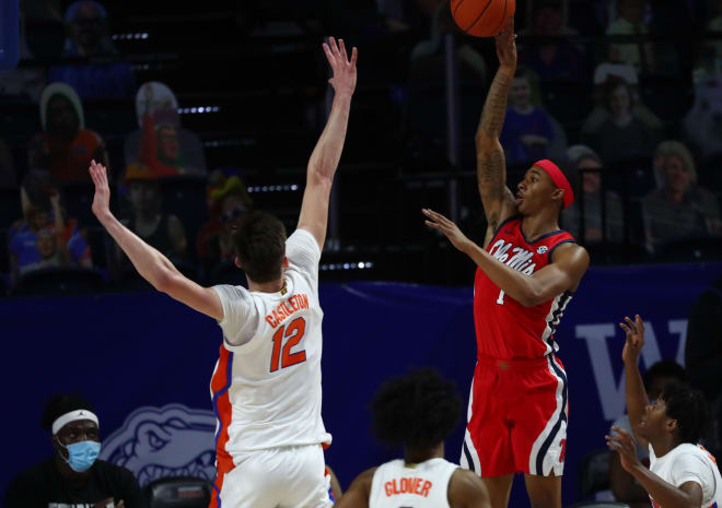 Ole Miss Rebels guard Austin Crowley (1) shoots over Florida Gators forward Colin Castleton (12) during the first half at Billy Donovan Court at Exactech Arena. Mandatory Credit: Kim Klement-USA TODAY Sports