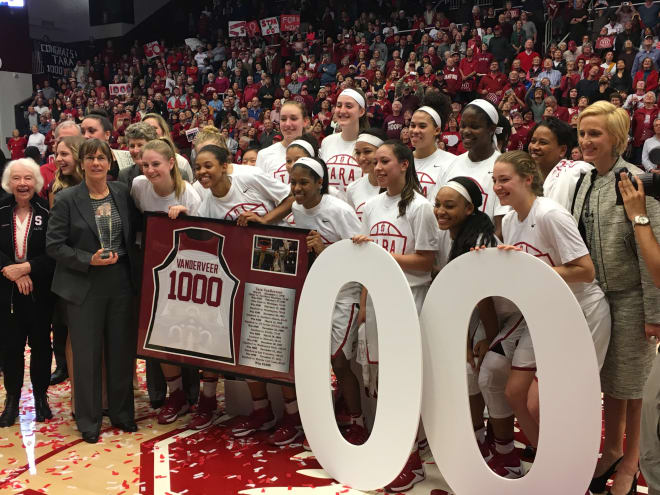 Head coach Tara VanDerveer celebrates win No. 1,000 with the team, assistant coaches and her mother, Rita, to her right.