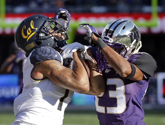 California wide receiver Bryce Treggs, left, fights for control of a pass with Washington defender Jordan Miller during the second half an NCAA college football game Saturday, Sept. 26, 2015, in Seattle. Treggs kept the ball for a first down. Cal won 30-24. (AP Photo/Elaine Thompson)