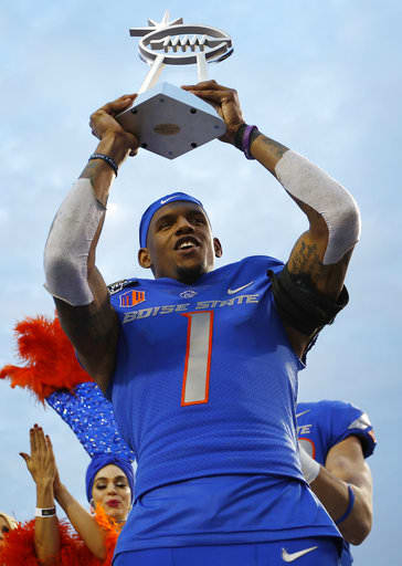 Boise State wide receiver Cedrick Wilson holds up the MVP trophy after his team defeated Oregon in the Las Vegas Bowl NCAA college football game Saturday, Dec. 16, 2017, in Las Vegas.
