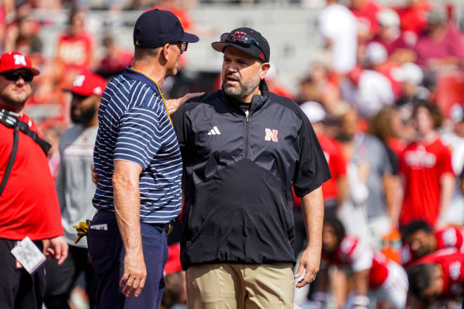 Nebraska football coach Matt Rhule alongside Michigan coach Jim Harbaugh