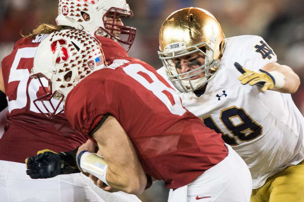Notre Dame's Greer Martini goes to tackle Stanford's Kevin Hogan in last year's game.