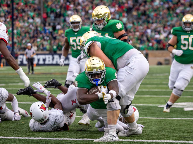 Running back Jeremiyah Love scores Notre Dame's final touchdown on a 32-yard screen play in a 31-24 victory over Louisville.