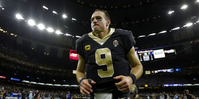 New Orleans Saints quarterback Drew Brees (9) walks off the the field following a win against the Carolina Panthers at the Mercedes-Benz Superdome.