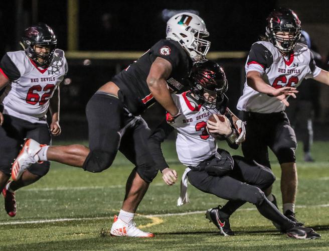 Frederick Douglass DL Jalen Hand drops Owensboro QB Kasey Boone. (Photo Credit: Messenger-Inquirer)