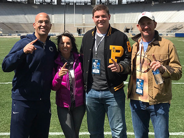 Culpepper and his parents pose for a photo with James Franklin inside Beaver Stadium. 