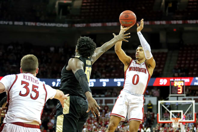 Point guard D'Mitrik Trice tries to take advantage of a mismatch for a late shot-clock jumper. The attempt would miss but UW got the offensive rebound.