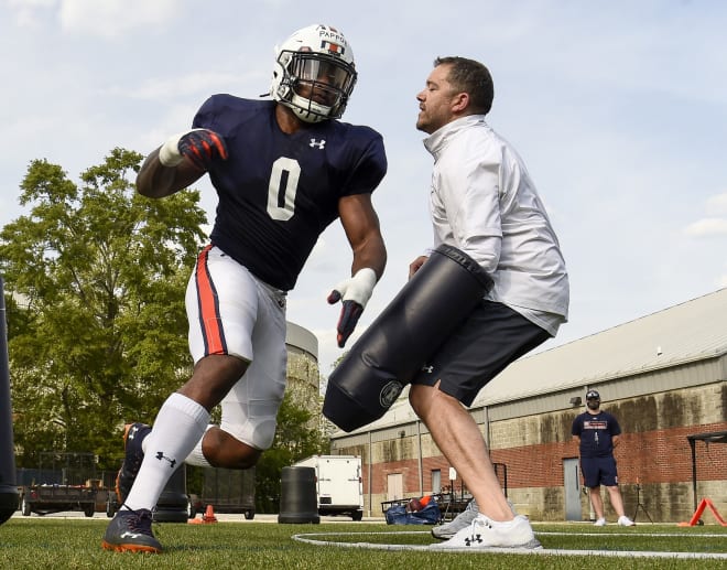 Owen Pappoe goes through a drill with ILB coach Jeff Schmedding.
