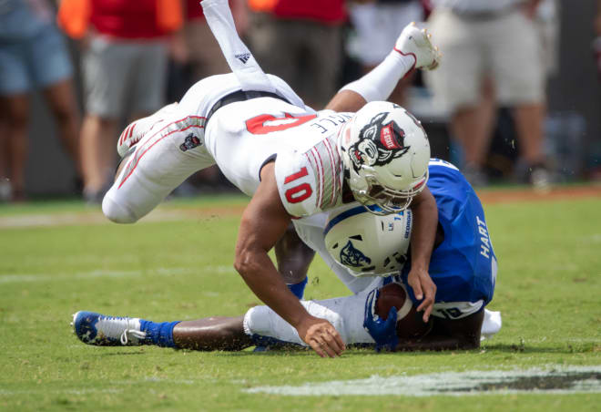 NC State Wolfpack football safety Tanner Ingle makes a tackle.