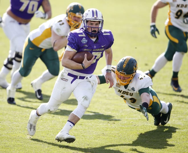 James Madison quarterback Bryan Schor (17) rushes up the field as North Dakota State linebacker Nick DeLuca (49) attempts to tackle him during the second half in the FCS championship NCAA college football game at Toyota Stadium in Frisco, Texas, Saturday, Jan. 6, 2017. 
