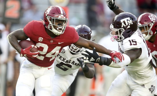 Alabama running back Trey Sanders (24) tries to get away from Texas A&M defensive lineman Jeremiah Martin (15) as he runs the ball at Bryant-Denny Stadium. Alabama defeated A&M 52-24. Photo | Imagn