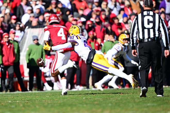 LSU freshman linebacker Harold Perkins Jr. records one of his school single-game record-tying four sacks in the Tigers' 13-10 victory at Arkansas on Saturday. LSU was crowned the SEC West Division champ later in the day when Alabama won at Ole Miss.