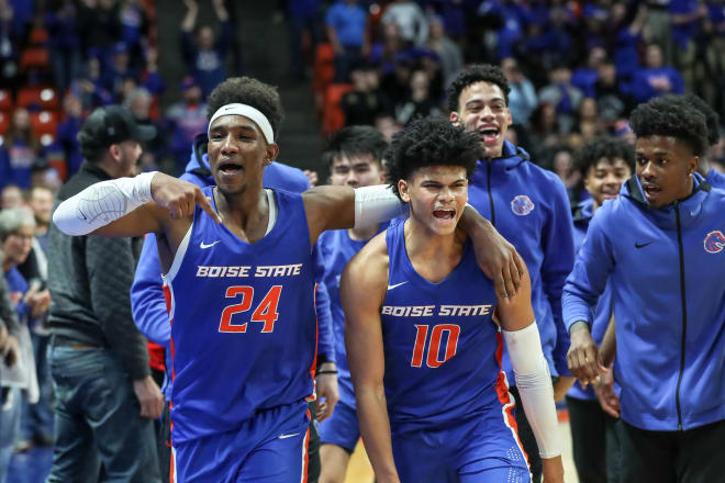 BOISE, ID - JANUARY 18: Forward Abu Kigab #24 and guard RayJ Dennis #10 of the Boise State Broncos celebrate an upset overtime win against the Utah State Aggies at ExtraMile Arena on January 18, 2020 in Boise, Idaho. Boise State won the game in overtime 88-83.