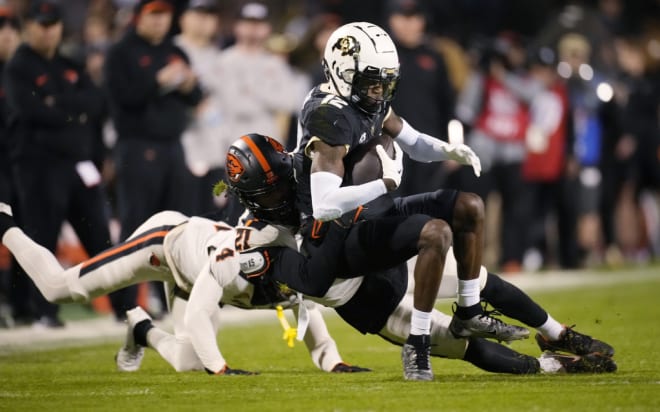 Noble Thomas (21) and Jaden Robinson (4) take down Colorado's Travis Hunter