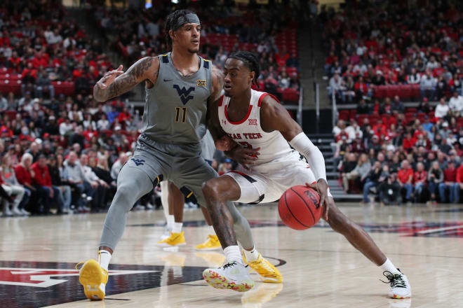 Texas Tech Red Raiders guard Davion Warren (2) works the ball against West Virginia Mountaineers forward Jalen Bridges (11) in the first half at United Supermarkets Arena.