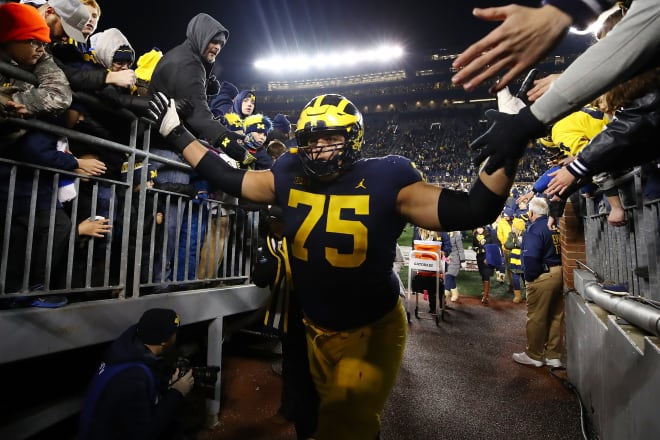 Michigan Wolverines football fifth-year senior left tackle Jon Runyan Jr. was named a first-team All-Big Ten performer by the coaches last season.