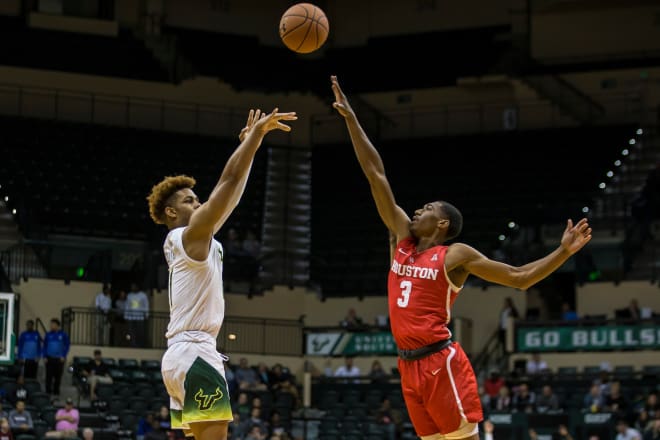 USF guard David Collins (left) shoots over Houston Cougars Armoni Brooks (3) during the first half at the Sun Dome