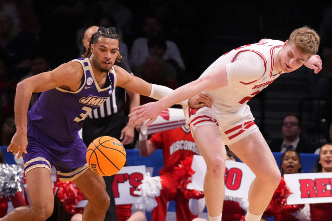 JMU's T.J. Bickerstaff, left, steals the ball from Wisconsin's Steven Crowl on Friday night. 