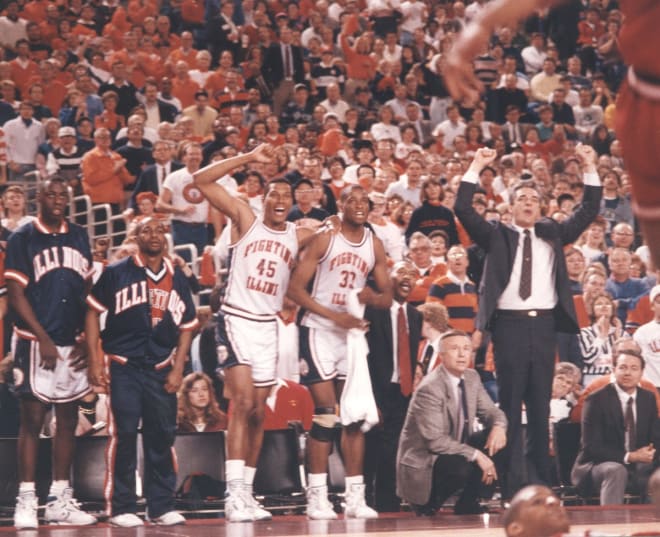 Lowell Hamilton (45), Kenny Battle (33) and coach Lou Henson watch from the sideline during a game in the 1988-89 season