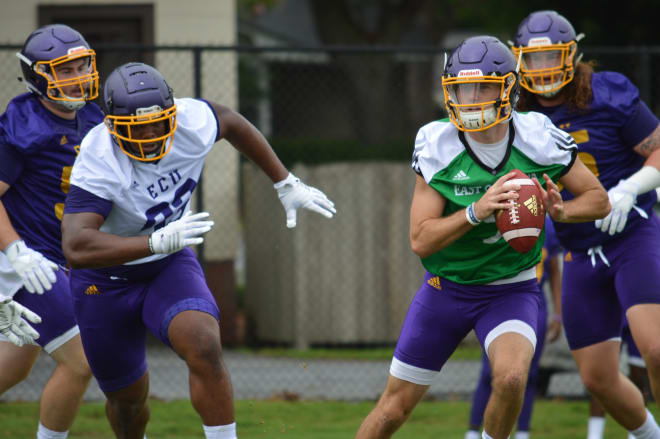 ECU quarterback Reid Herring rolls out of the pocket on day one of fall camp Friday morning at Hight Field.