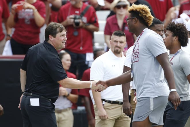 Will Muschamp shakes hands with eventual five-star signee Jordan Burch during a game visit at Williams-Brice Stadium