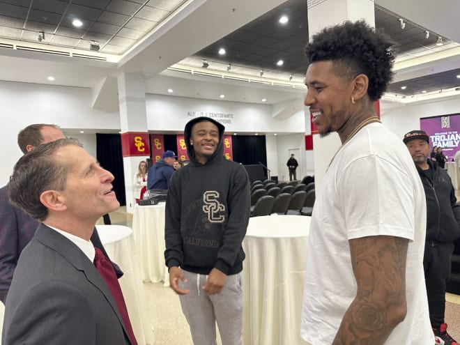 Eric Musselman chats with Nick Young and Isaiah Collier at his introductory press conference Friday.