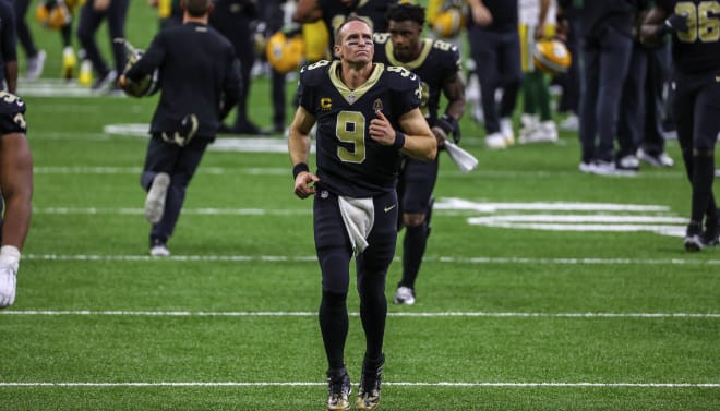New Orleans Saints quarterback Drew Brees (9) runs off the field following a loss against the Green Bay Packers during the second half at the Mercedes-Benz Superdome.