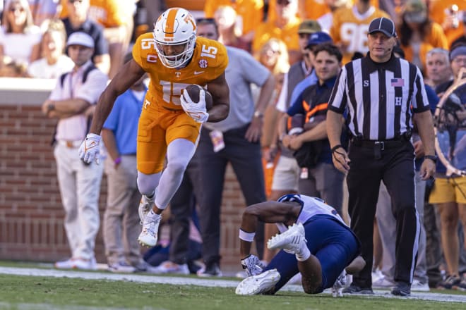 Tennessee wide receiver Bru McCoy (15) leaps to avoid being tackled by UTSA linebacker Donyai Taylor, bottom right, during the first half of an NCAA college football game Saturday, Sept. 23, 2023, in Knoxville, Tenn.