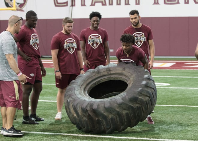 Florida State sophomore Keyshawn Helton flipped this large tire 22 times during a timed event at Saturday's Lift for Life.